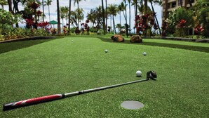 A miniature golf course with a putting green, a hole, and a golf ball in motion. - Maui 2BR Island-View Villa at Marriott’s Ocean Club - Full Kitchen & Balcony (Lahaina)