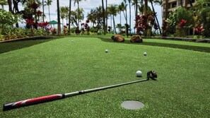 A miniature golf course with a putting green, a hole, and a golf ball in motion. - Maui 2BR Island-View Villa at Marriott’s Ocean Club - Full Kitchen & Balcony (Lahaina)