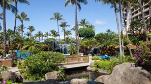 A tropical resort with a waterfall, palm trees, and a bridge over a small stream. - Maui 2BR Island-View Villa at Marriott’s Ocean Club - Full Kitchen & Balcony (Lahaina)