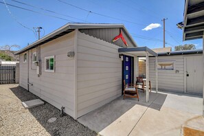 A small, single-story building with a flat roof, a door, and a window. - Dual-Home Property with Private Patio (Henderson)