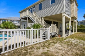 A two-story house with a covered porch, a pool, and a fenced yard. - NEW- Salt Therapy - 5 BDR- Pool- St. George Island (Saint George Island)