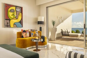 A modern living room with a yellow sofa, a round table, and a large window overlooking a balcony.