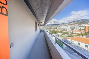 A balcony with a view of a town and hills. - Lux Mare Funchal by YOUR KEY (Funchal)