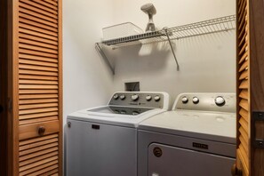 A laundry room with a Maytag washer and dryer, a drying rack, and a ceiling-mounted hairdryer. - VIEWS! / Hot Tub / Panoramic Mountain View Sauna / Games! (Sevierville)