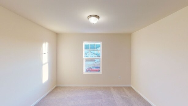 A room with a carpeted floor, a ceiling light, a window with a view of a building and a car, and plain walls. - Near Shelbyville, TN. Perfect for long term stays (Murfreesboro)