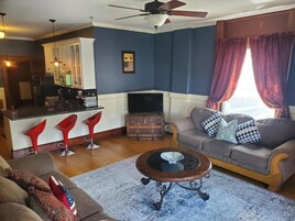 Una sala de estar con un sofá, una mesa de centro, un televisor y una chimenea.
