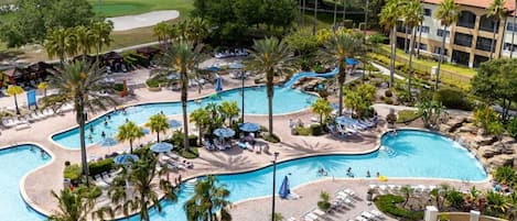 A resort with multiple swimming pools, palm trees, and lounge areas.