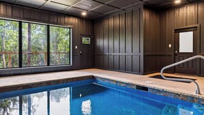 A swimming pool with a clear view of the surrounding area, including a wooden deck and a door. - Spurling Retreat by Avantstay Sleeps 20 + Indoor Pool + Game Room Near Pigeon Forge (Sevierville)