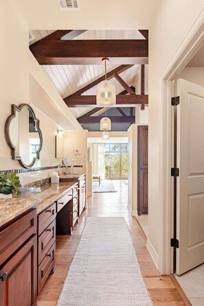 A kitchen with wooden cabinets, a marble countertop, and a large window. - Luxury Estate Spa Bathroom, Observation Deck, Pool (Driftwood)