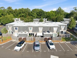 A multi-story residential building with a parking lot. - Minutes to Wrightsville Beach, Downtown & UNCW (Wilmington)