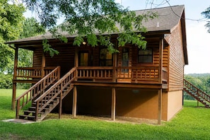 A wooden cabin with a porch, a staircase, and a covered area. - River View Cabin on the White River (Calico Rock)