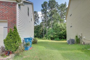 A residential area with two houses, a small lawn, and a tall tree. - Shop, Dine & Hike: Lawrenceville Home By Parks (Lawrenceville)