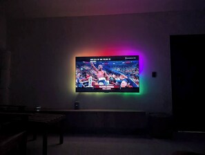 A television mounted on a wall displaying a sports event. - Penthouse with 360 views (Santiago de los Caballeros)
