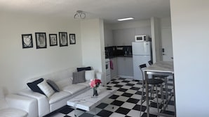 A modern apartment with a living room, kitchen, and dining area. - Spacious Studio Apartment Best Location (Miami Beach)
