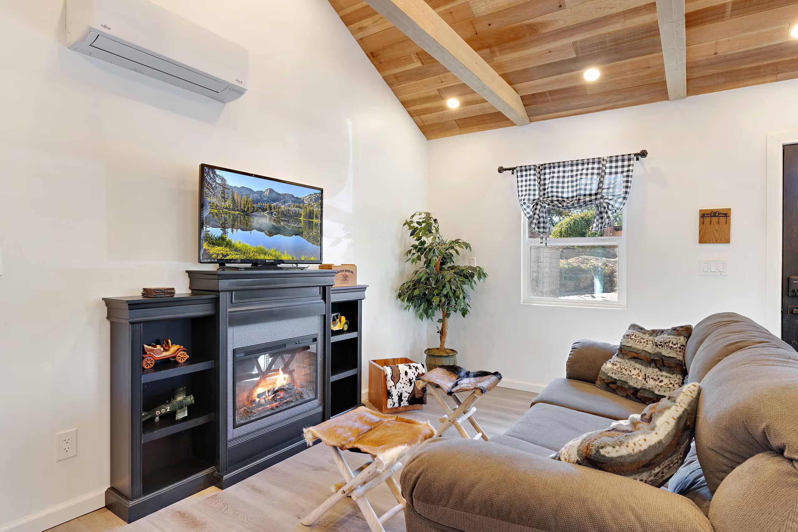 A living room with a fireplace, a television, and a sofa.