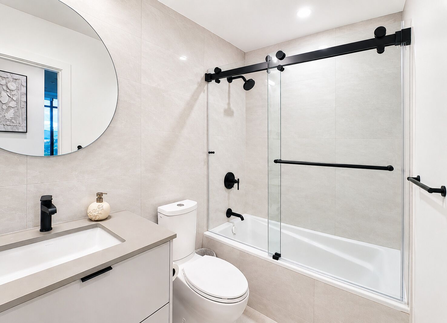 A modern bathroom with a glass-enclosed shower, a toilet, and a sink with a soap dispenser.