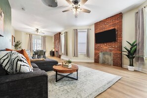 Una sala de estar con sofá, mesa de centro y chimenea.