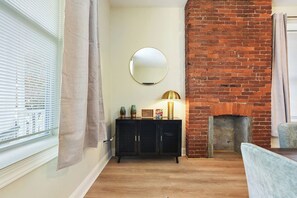 Stylish dining area with exposed brick accents and ambient lighting for a cozy atmosphere - Games+Netflix+BBQ+FREE Parking Near Bakery Square (Pittsburgh)