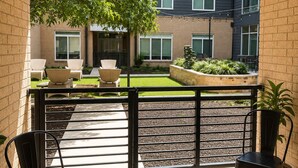 A balcony with a view of a building, a grassy area, and a seating arrangement. -     Luxury River Walk Retreat 2BR Downtown (San Antonio)