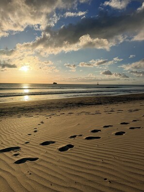 A beach with footprints in the sand and a ship in the distance. - Studio apartment with ocean view, minutes away from the beach, surf, & swimming! (San Juan del Sur)