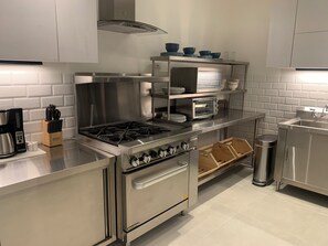 A modern kitchen with stainless steel appliances, a built-in oven, and a toaster. - The Palm, Beachfront Home in Playa Hermosa, Jaco, Costa Rica. Prime location (Playa Hermosa)