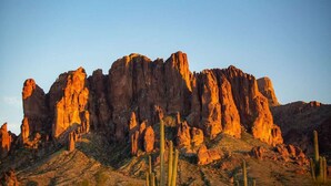 A desert landscape with prominent rock formations and cacti. - Desert Estate at the Base of the Superstition Mountains (Apache Junction)