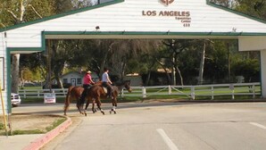A covered equestrian center entrance with a sign for 'Los Angeles Equestrian Center' and a phone number. - 3-bedroom house in charming Burbank with cool AC (Burbank)