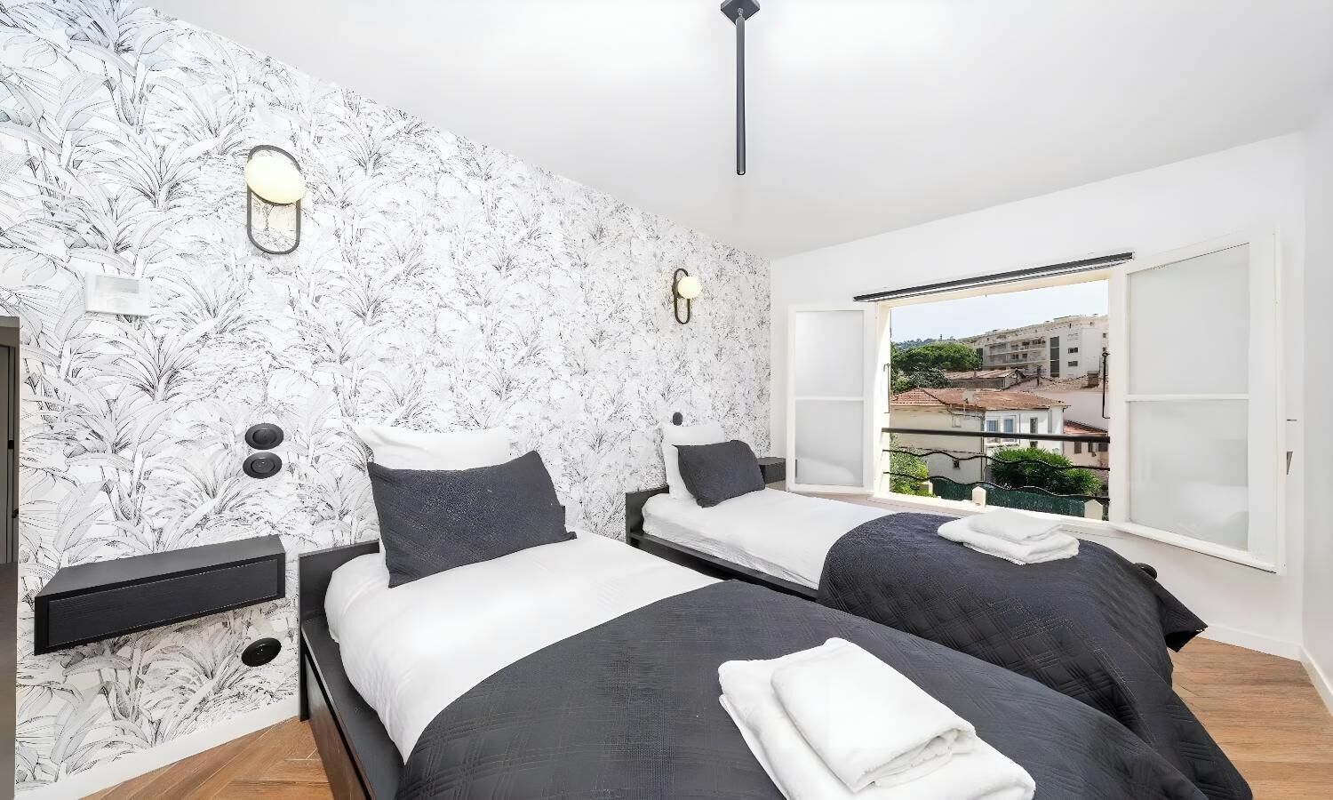 Ein Schlafzimmer mit zwei Betten, Stadtblick und modernem Design.