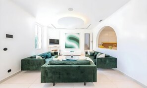 A modern living room with a sofa set, a flat-screen TV, and a large abstract painting. - POOL FRENCH VILLA WITH GYM , SAUNA - IN THE HEART OF CANNES- 250 SQM (Cannes)