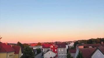 A residential area with buildings, a street, and a clear sky.