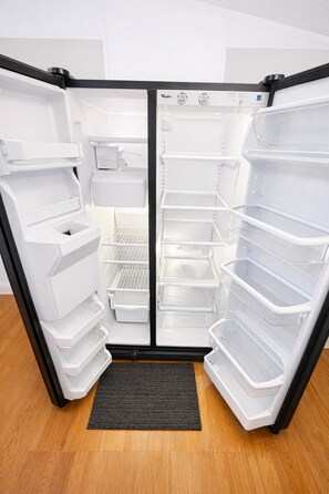 An open refrigerator with multiple shelves and a water dispenser. - 2-bedroom mobile home in fantastic Hartwell with free space for boat rv parking  (Hartwell)