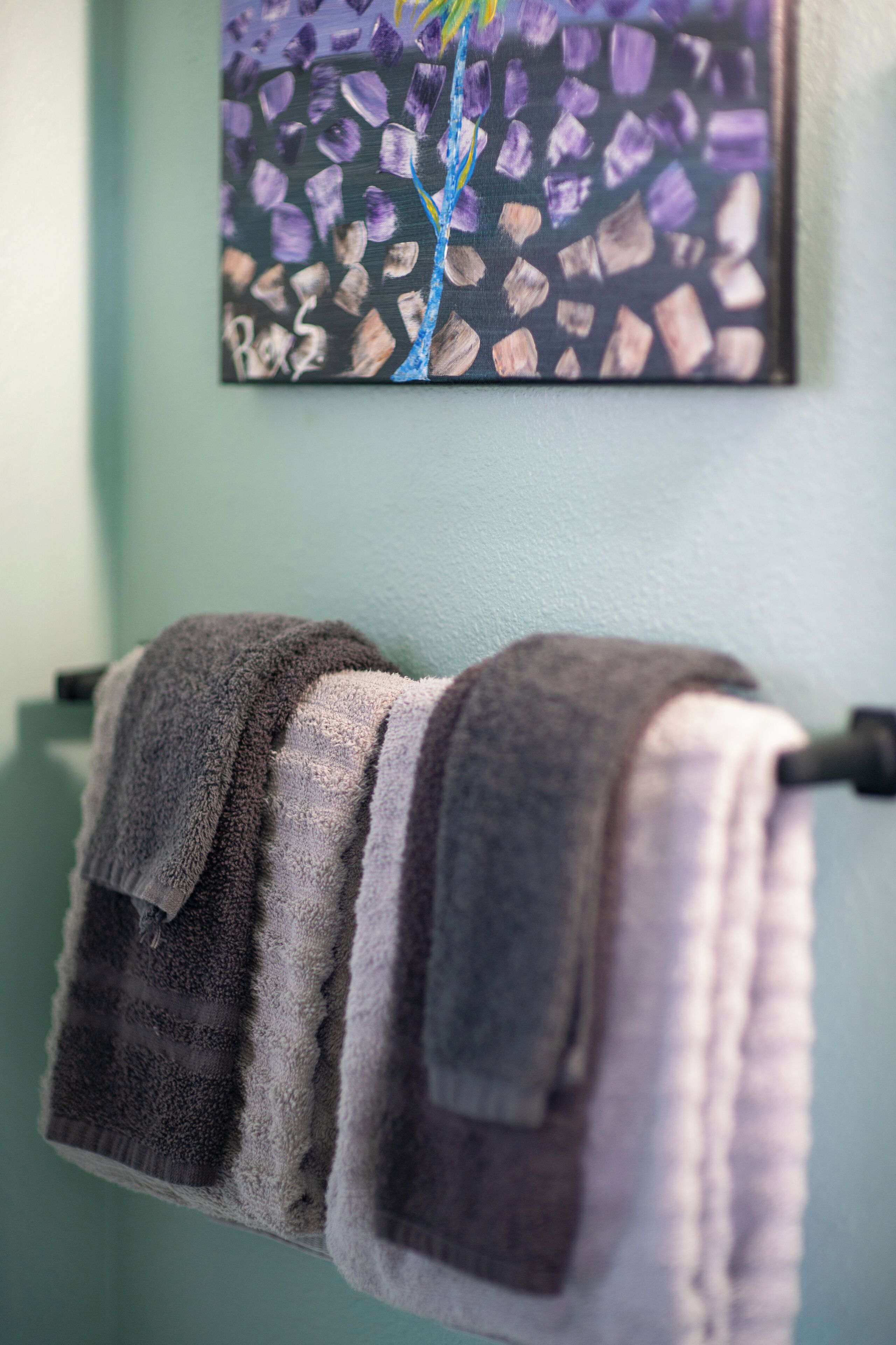 A towel rack with two towels.