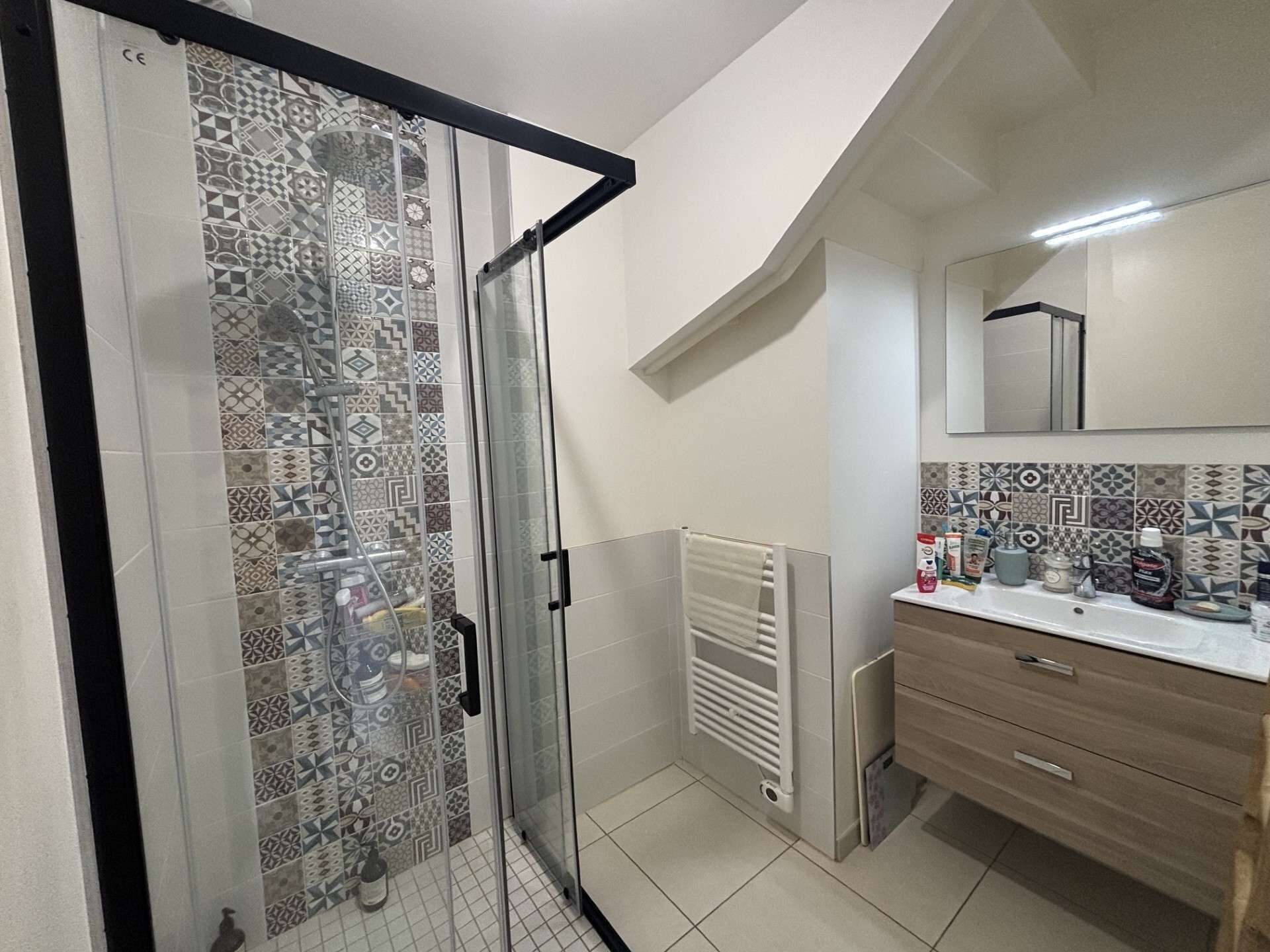 A bathroom with a shower, toilet, and sink.