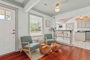 A room with two chairs, a small table, and a rug. - 1111 Simmons St - MTP (Mount Pleasant)