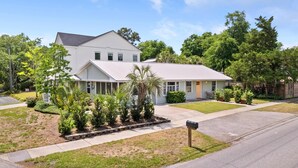 A single-story house with a front porch, a driveway, and a mailbox.