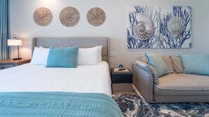 A hotel room with a bed, a sofa, and artwork on the wall. - R603 Full Unit Luxury Oceanfront Retreat with Stunning High Floor Beachfront Views (Puerto Peñasco)