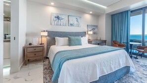 A modern hotel room with a large bed, a desk, a chair, and artwork on the walls. - One-bedroom condo at Encantame Soleil with king bed, ideal for a coastal escape. (Puerto Peñasco)