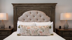 A bedroom with a tufted headboard, a bed with white linens, two bedside tables with lamps, and a floral-patterned pillow. - R804 Encantame Soleil 3BR Ocean View Condo with Modern Kitchen and Private Balcony (Puerto Peñasco)