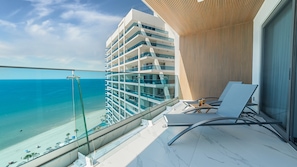A balcony with a clear view of the ocean and a high-rise building with multiple balconies. - R1701 Beachfront 3BR Condo with Dual Balcony Access & Spacious Open Living (Puerto Peñasco)