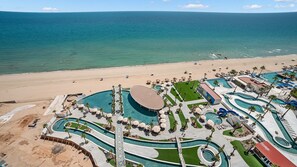 A resort with multiple swimming pools, a beach, and a clear view of the ocean. - R1605 2BR, 2BA condo on the 14th floor at Encantame Soleil in Puerto Peñasco. (Puerto Peñasco)