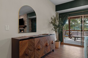 A modern kitchen with a built-in oven, a large mirror, and a potted plant. - Resort Pools & Lazy River | 6BR Sleeps 14 (Hollister)