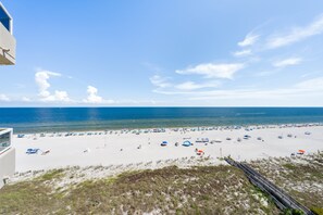 A beach with a clear sky, a sandy shore, and a view of the ocean. - Beautiful Beach Front Condo With Breathtaking Views (Orange Beach)