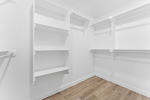 A corner of a room with white walls and wooden flooring. - Unforgettable 4BD Oasis in West Texas (Midland)