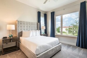 A hotel room with a large bed, two bedside tables, a lamp, and a view of the outdoors. - The Eighteen at Bear's Den, Water Park, Golf Views, Near Disney (Kissimmee)