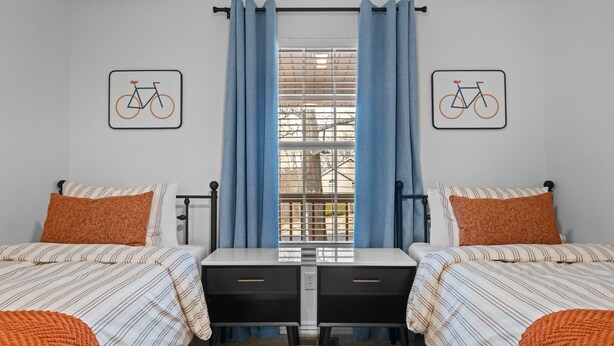 A double room with two beds, a window with blinds, and a view of the outside. - The Witherby Woodland Retreat (Bella Vista)