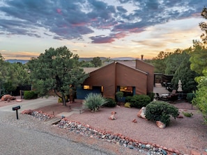 A modern house with a patio and a driveway. - Red Mountain Shadows Retreat: Sleeps 6 in West Sedona Near Hiking Trails, Park & Bike Paths (Sedona)
