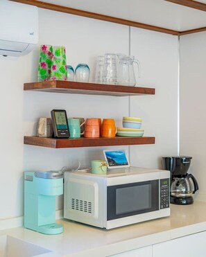 A kitchen with a microwave, coffee maker, and various kitchenware on shelves. - Secret Beach Escape with Pool! Off Season Rates! (San Pedro)