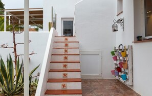 A white staircase with red star-shaped markers, leading to a door with a window. - Gorgeous home in Mojacar with private swimming pool, can be inside or outside (Mojacar)
