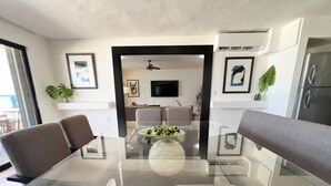 A modern dining area with a glass table and four cushioned chairs. - TOP/3BR/First Line Ocean Front Villa/2 Terrace/HZ (Cancún)