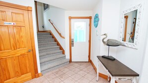 A staircase leading to a door with a 'Private' sign, a wall-mounted mirror, and a bird statue on a table. - Oceanside, 2 Hot Tubs- 2 Duplex's rents as 1-BU22, Love R Shack at the Beach (Corolla)